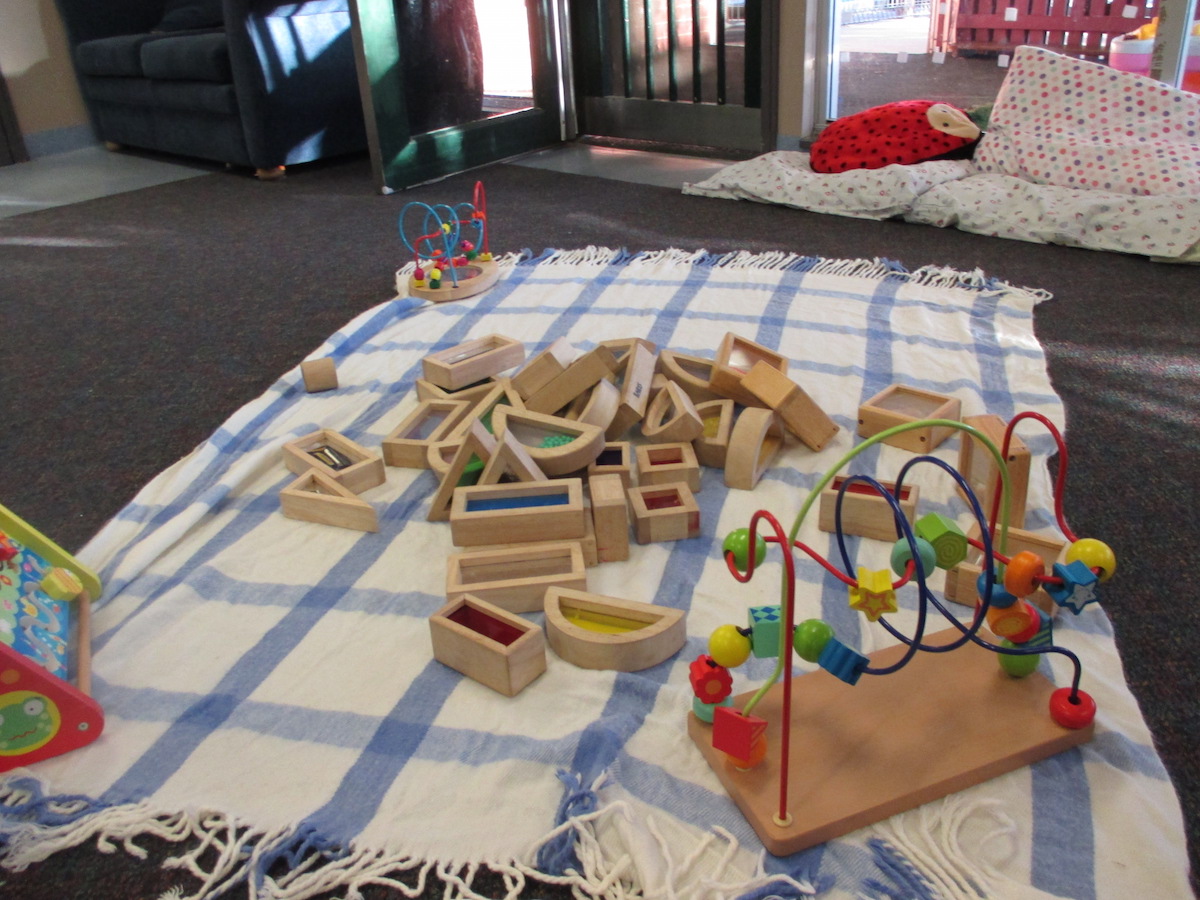 Wooden toys and pillows in the babies room